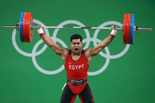 RIO DE JANEIRO, BRAZIL - AUGUST 10: Mohamed Mahmoud of Egypt lifts during the Men's 77kg Group A weightlifting contest on Day 5 of the Rio 2016 Olympic Games at Riocentro - Pavilion 2 on August 10, 2016 in Rio de Janeiro, Brazil. (Photo by Julian Finney/Getty Images)